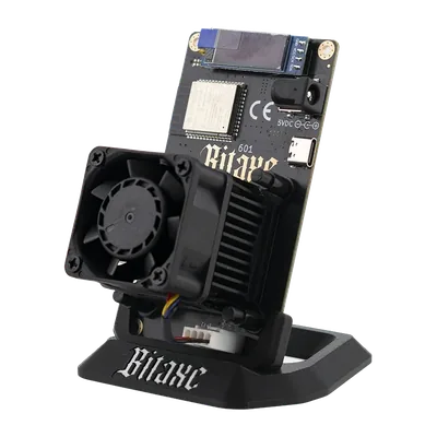 Bitaxe Gamma open-source Bitcoin miner on its stand, fan and black heatsink over the BM1370 chip