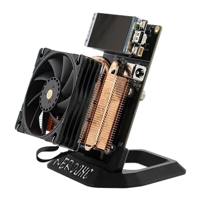 NerdAxe Gaia Pro seen at an angle from the front right: 60 mm fan, copper fins of the AXP60 Copperzilla cooler and colour display